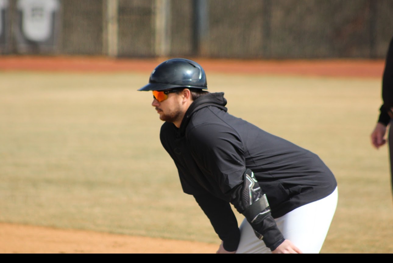 Coach Jake Woolwine on a baseball field
